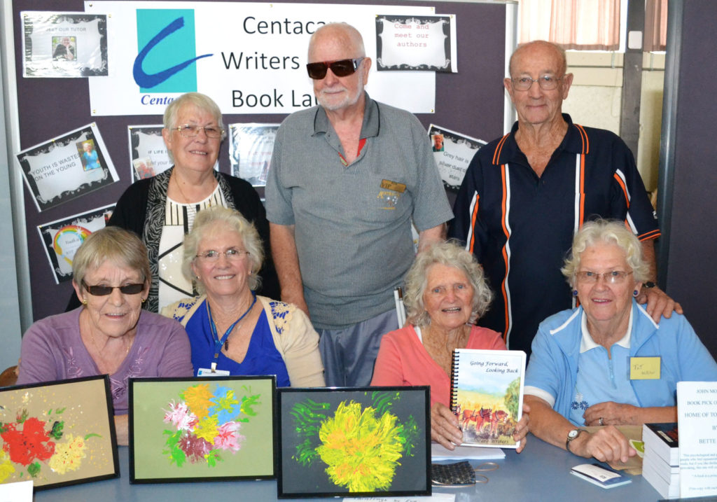 The CentacareCQ Writer’s Group proudly displaying their self-published book of stories ‘Going Forward, Looking Back’.